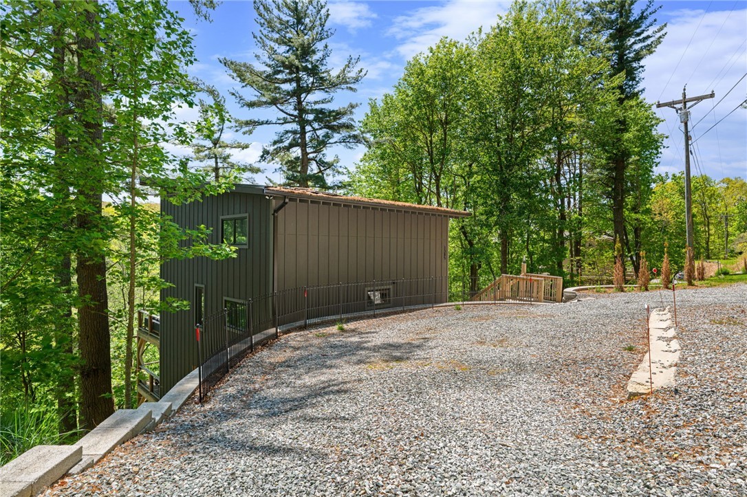 1385 Niley Cook Road Blowing Rock, NC 28605 - Photo 38 of 40 a backyard of a house with large trees and wooden fence