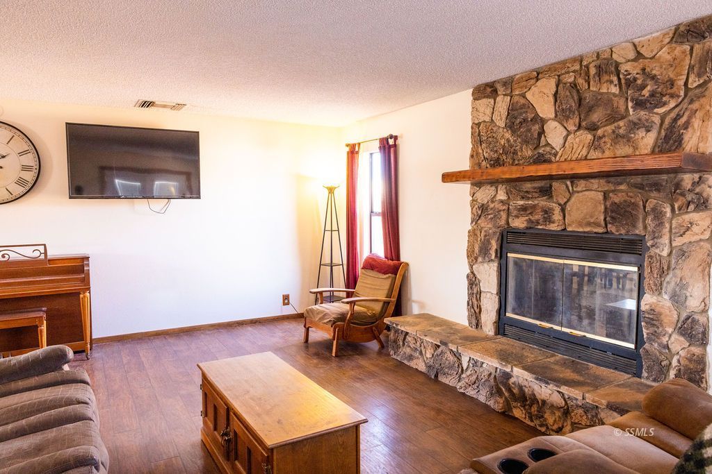 834 West Graaf Avenue Ridgecrest, CA 93555 - Photo 7 of 39 a living room with furniture and a fireplace