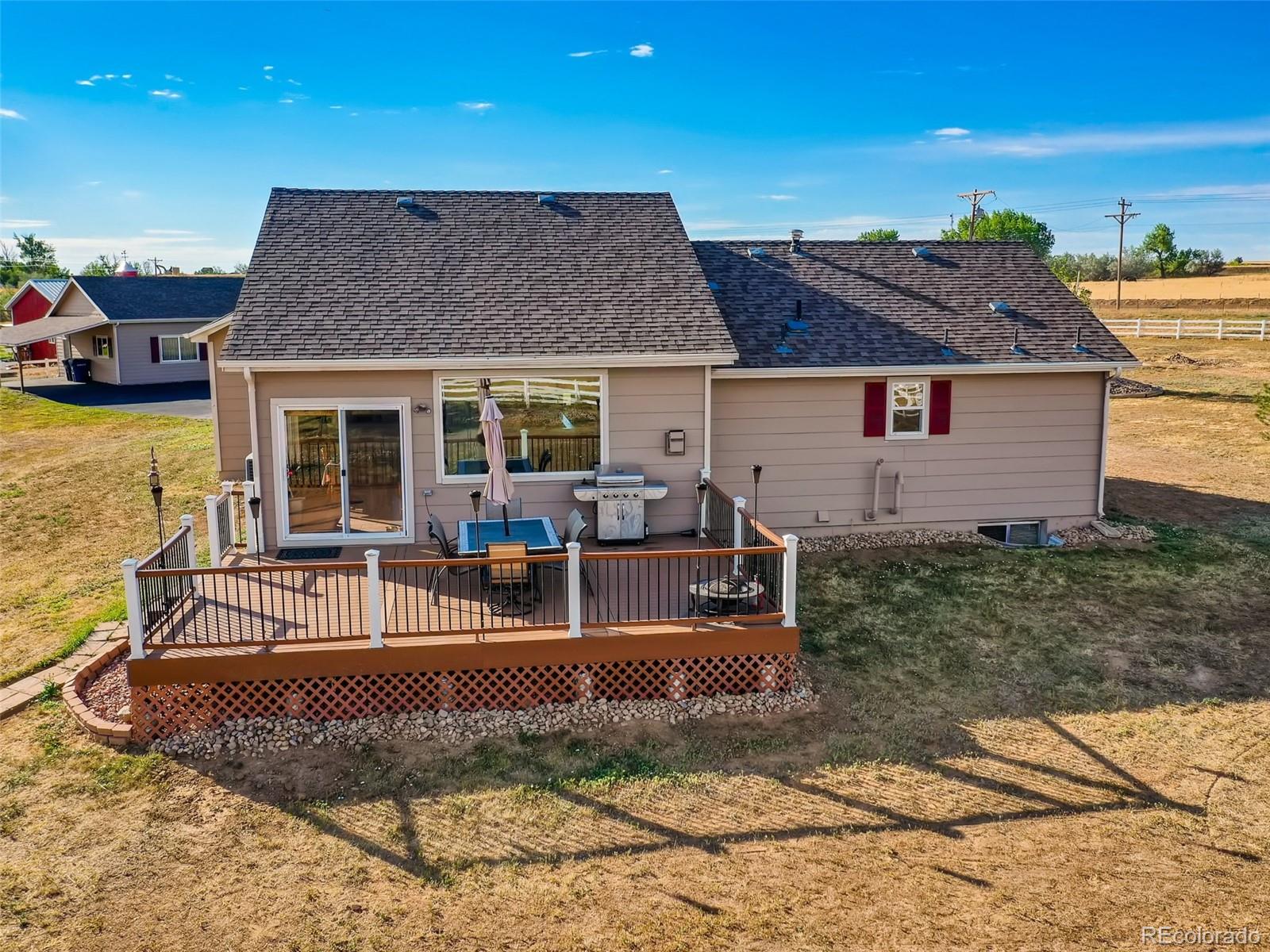 8209 County Road 2 Brighton, CO 80603 - Photo 18 of 40 a view of a house with backyard porch and sitting area