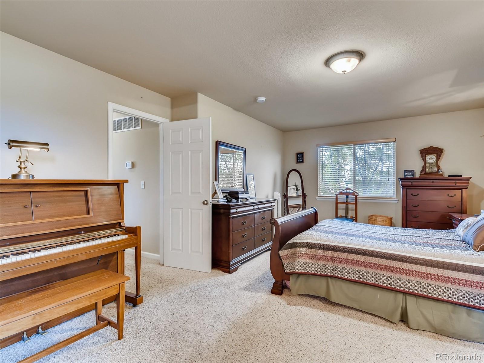 8209 County Road 2 Brighton, CO 80603 - Photo 22 of 40 a bedroom with a bed and a chandelier