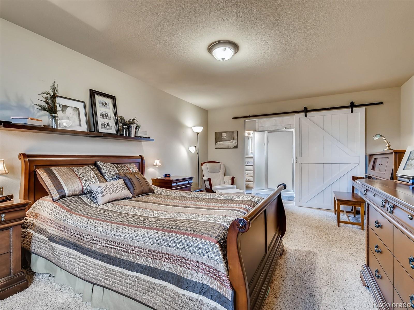 8209 County Road 2 Brighton, CO 80603 - Photo 23 of 40 a bedroom with a bed and a flat screen tv