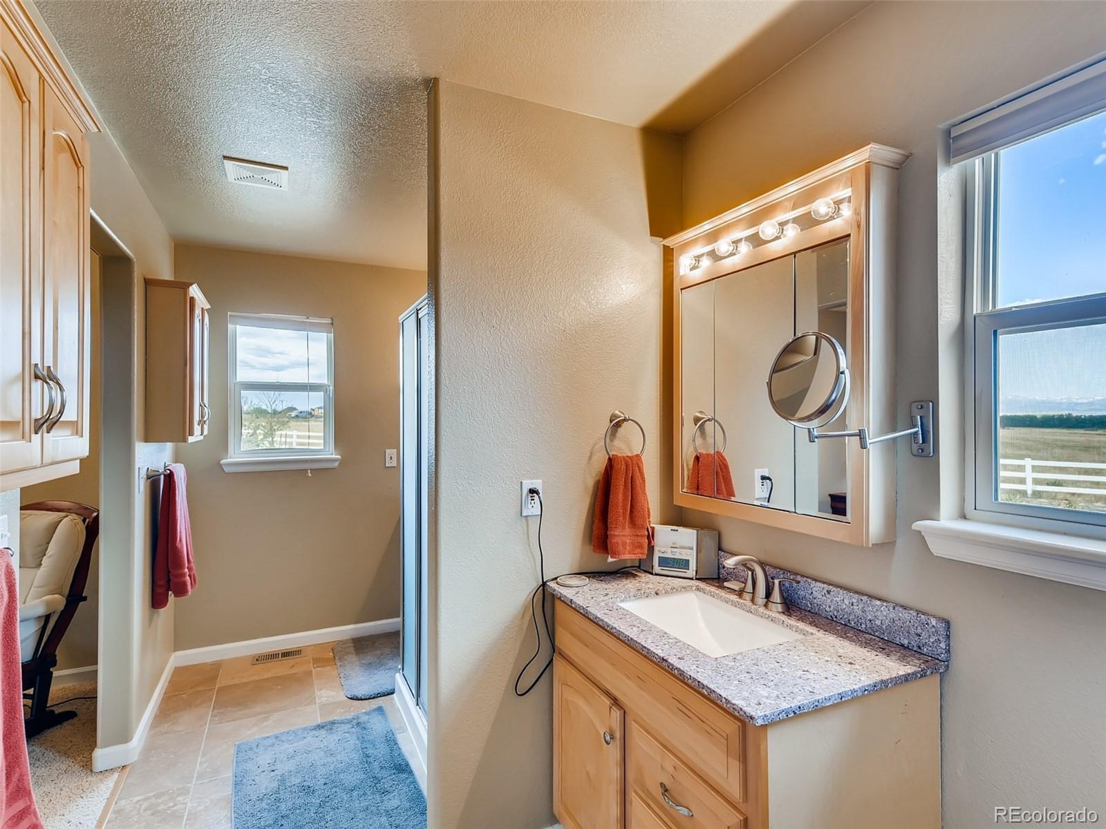 8209 County Road 2 Brighton, CO 80603 - Photo 24 of 40 a bathroom with a granite countertop sink and a mirror