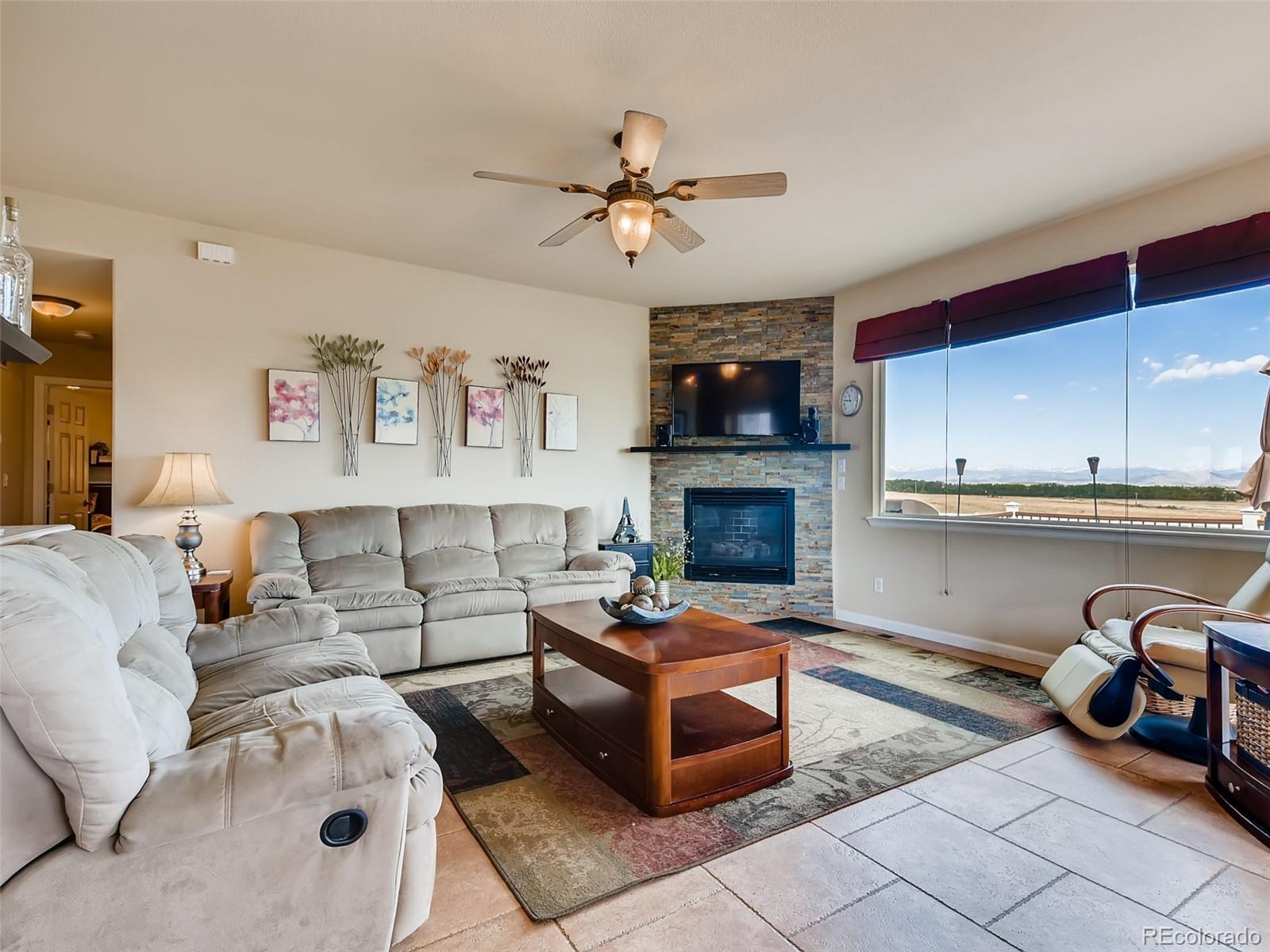 8209 County Road 2 Brighton, CO 80603 - Photo 8 of 40 a living room with furniture and a fireplace