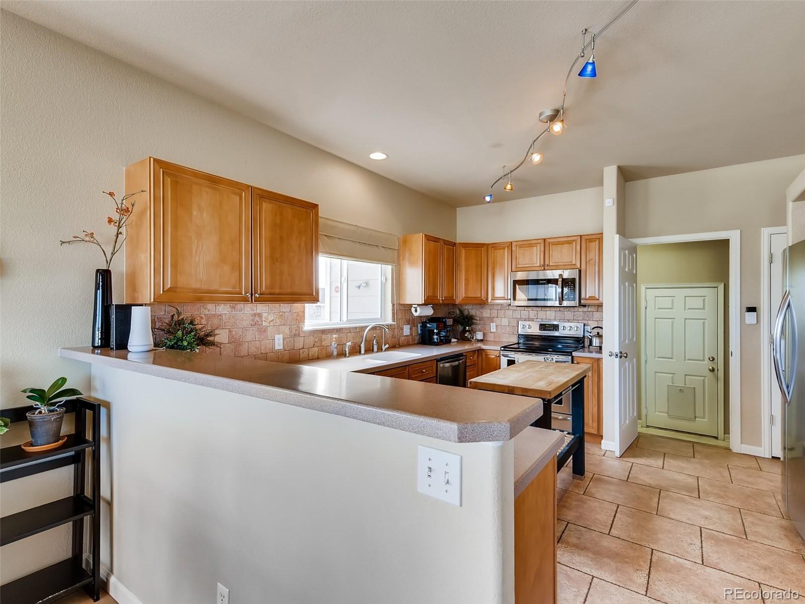 8209 County Road 2 Brighton, CO 80603 - Photo 9 of 40 a kitchen that has a sink and a stove top oven