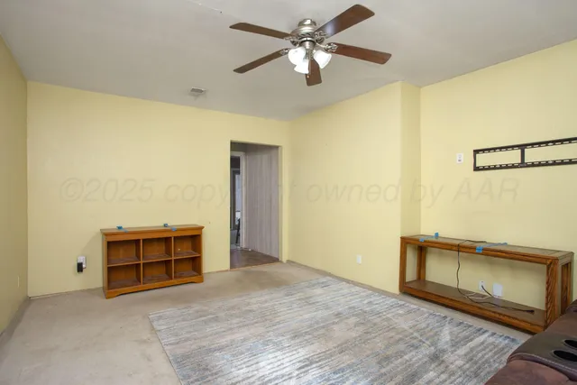 a view of room with hardwood floor and ceiling fan