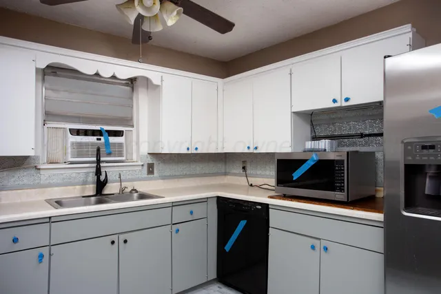 a kitchen with a sink cabinets and stainless steel appliances