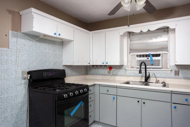 a kitchen with a sink cabinets and appliances