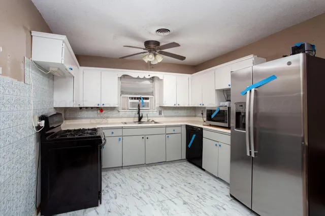 a kitchen with a sink stainless steel appliances and cabinets