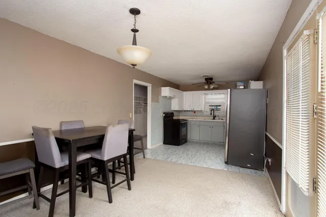 a kitchen with refrigerator cabinets and wooden floor