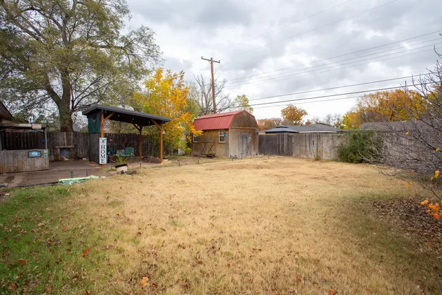 a backyard of a house with table and chairs