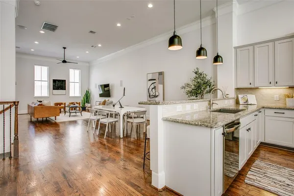 a kitchen with granite countertop a stove and a refrigerator