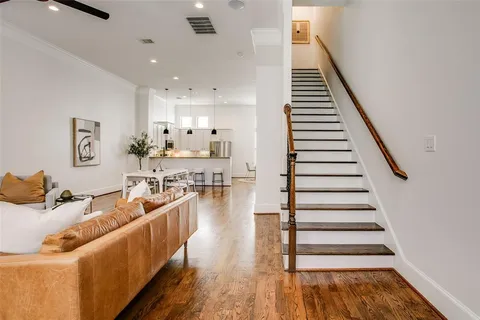 a living room with furniture wooden floor and a flat screen tv