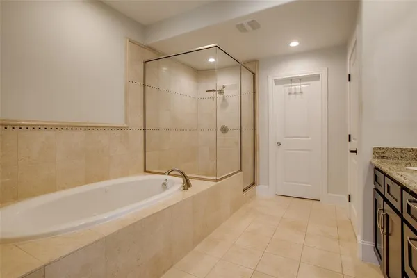 a spacious bathroom with a tub and shower