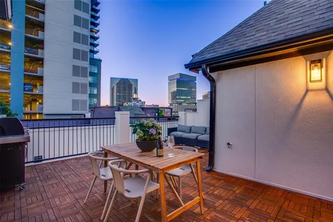 a backyard of a house with table and chairs