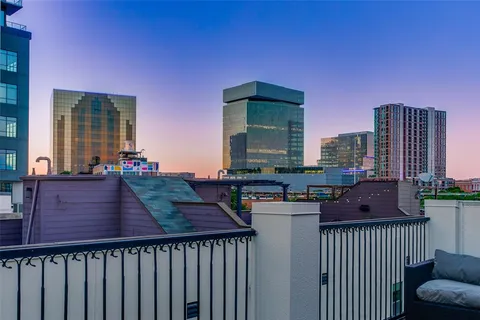 a view of a balcony with wooden floor and outdoor seating