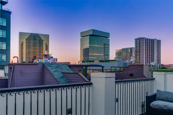 a view of a balcony with wooden floor and outdoor seating
