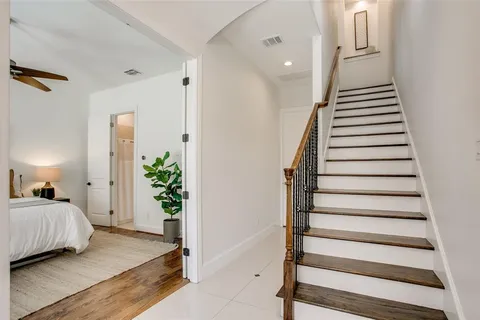 a bedroom with bed and hardwood floor