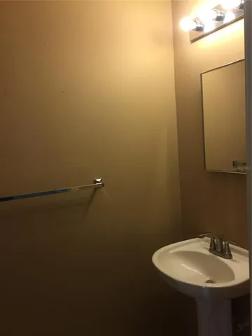 a white toilet sitting next to a white wall