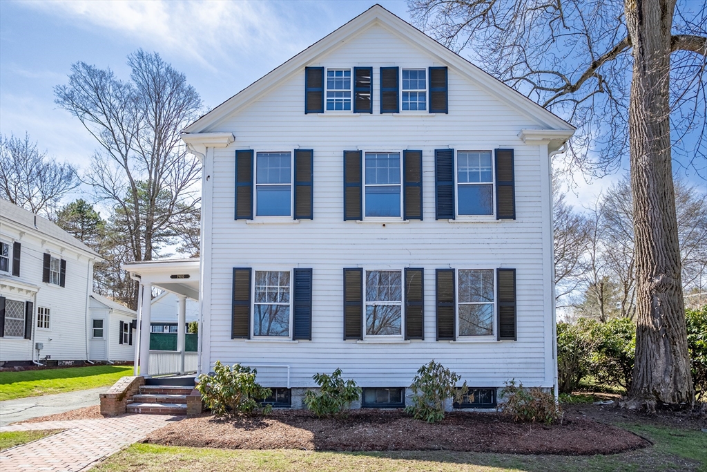 1900 Massachusetts Avenue Lexington, MA 02421 - Photo 12 of 15 a front view of a house with garden and trees