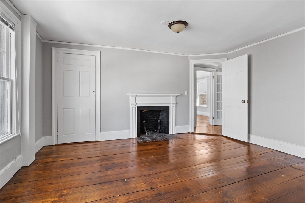 1900 Massachusetts Avenue Lexington, MA 02421 - Photo 9 of 15 a view of a livingroom with wooden floor and a fireplace