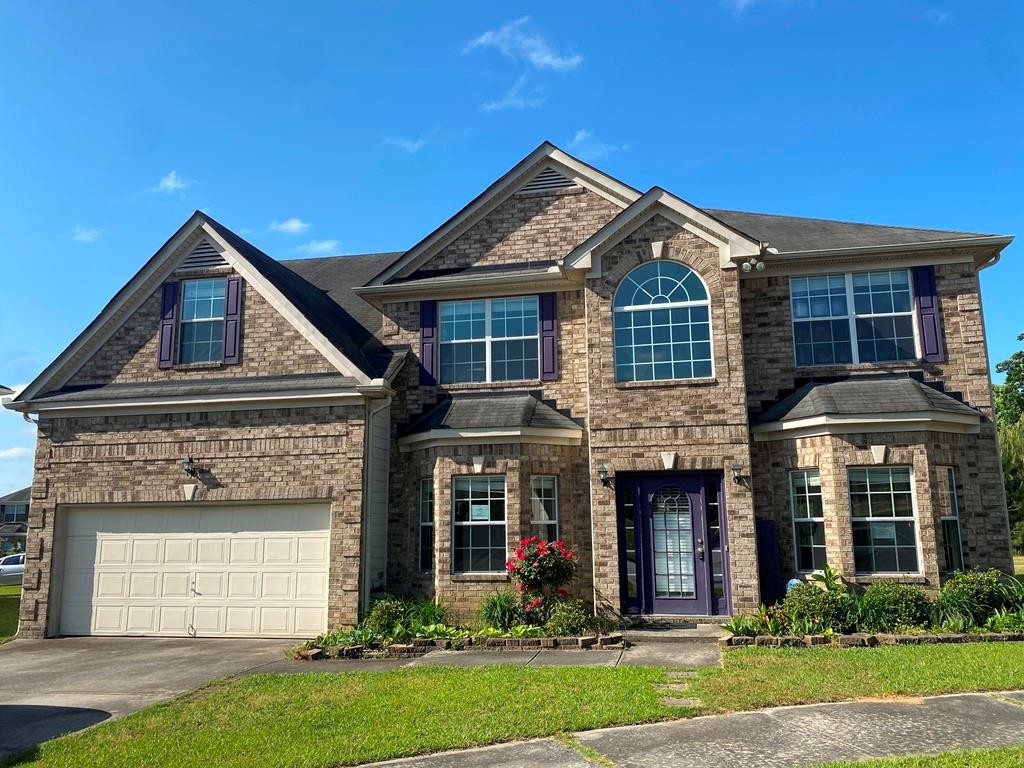 7265 Flint Way Lithonia, GA 30038 - Photo 1 of 1 front view of a house with a yard