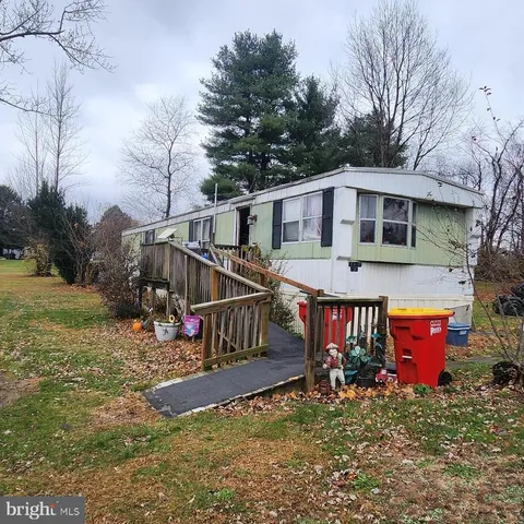 a view of a house with yard and sitting area