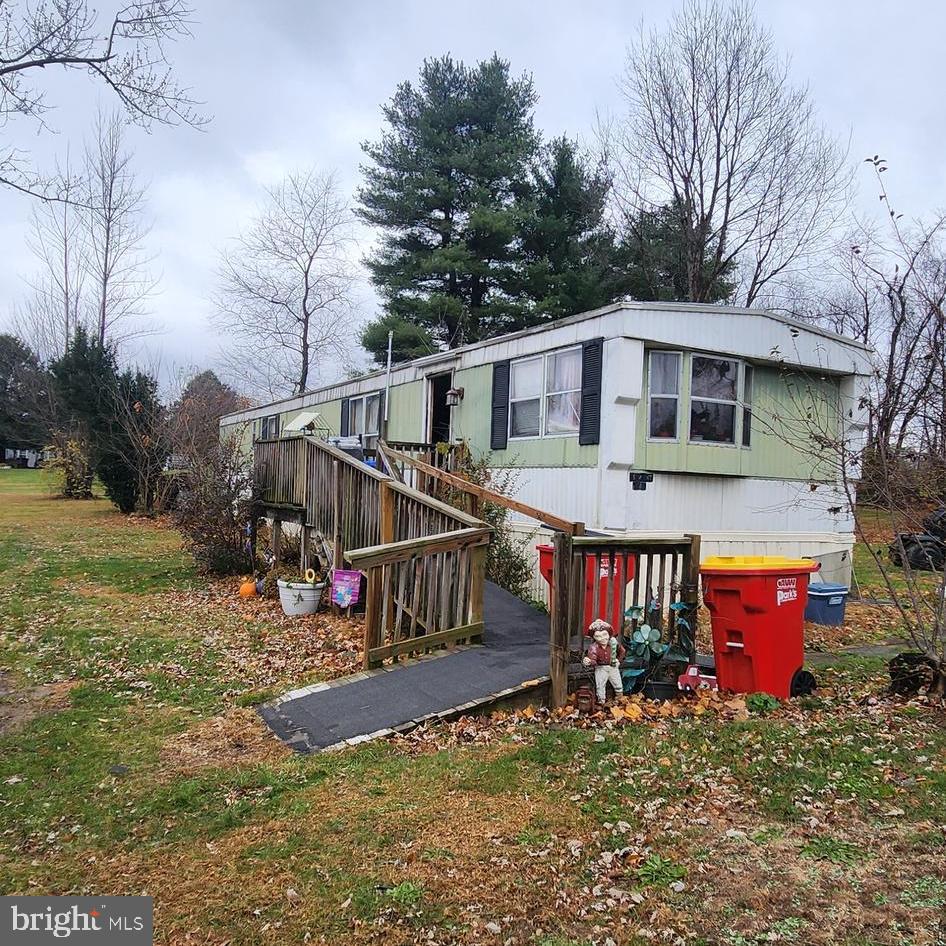 a view of a house with yard and sitting area