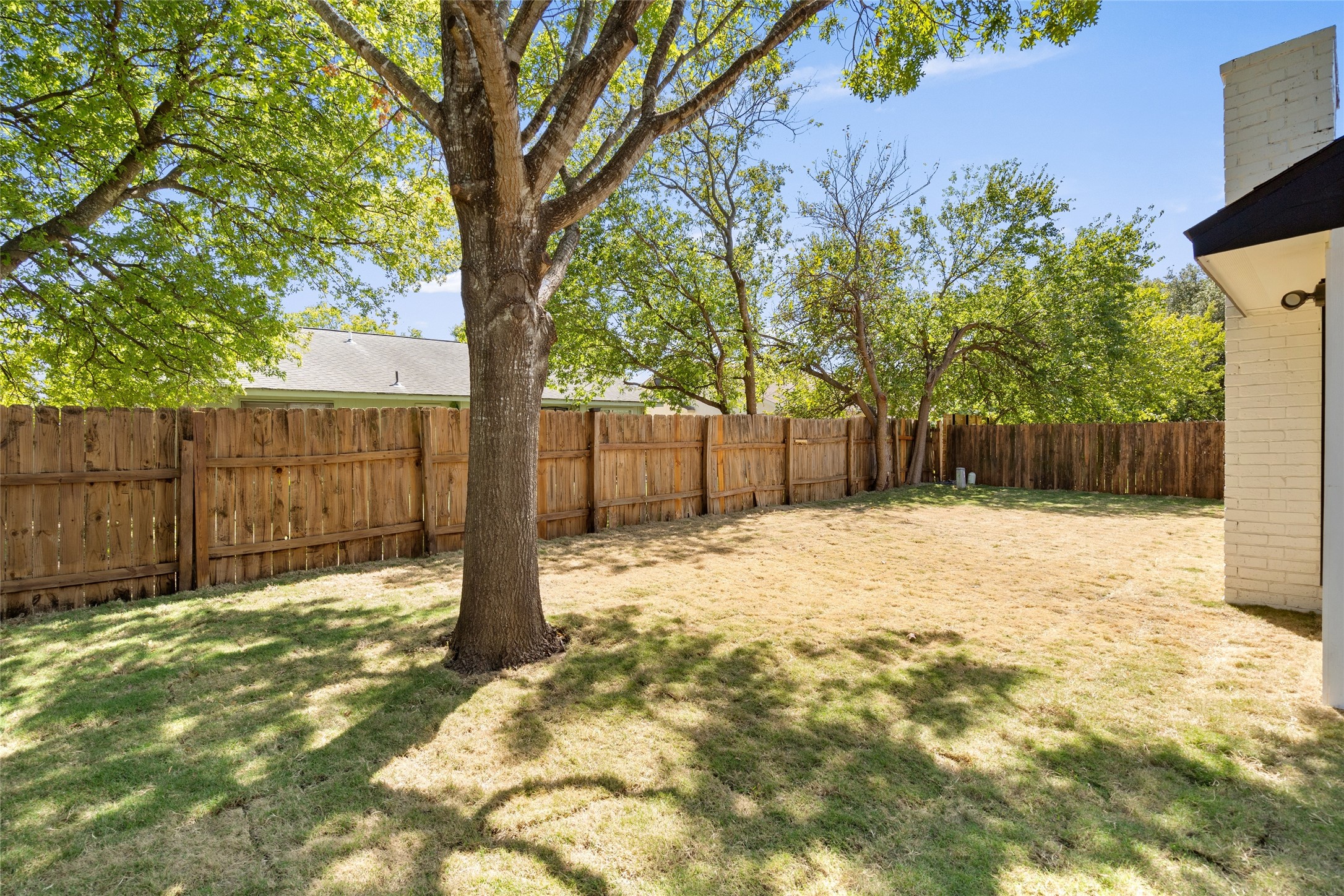 6901 Windrift Way Austin, TX 78745 - Photo 25 of 30 a backyard of a house with a large tree