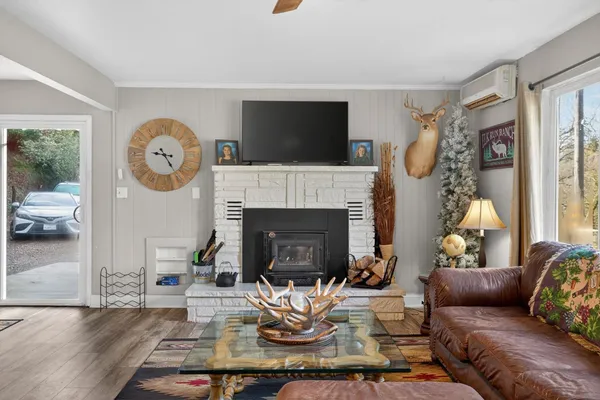 a living room with furniture fireplace and a flat screen tv