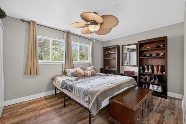 a bedroom with a bed and a large window