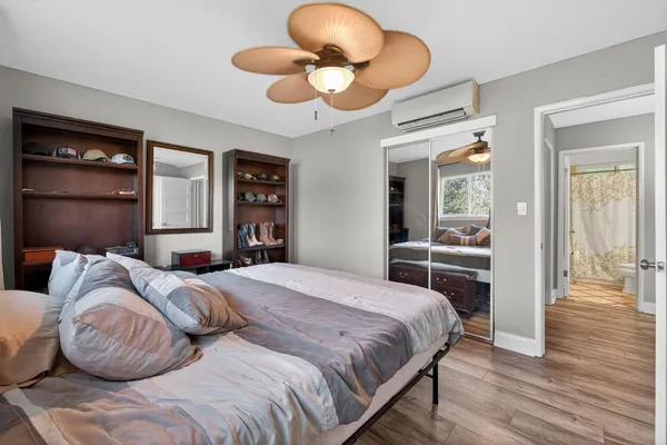 a bedroom with a bed and wooden floor