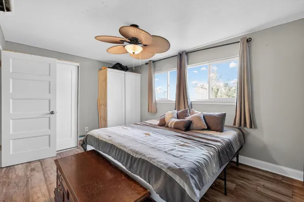 a bedroom with a large bed and a large window