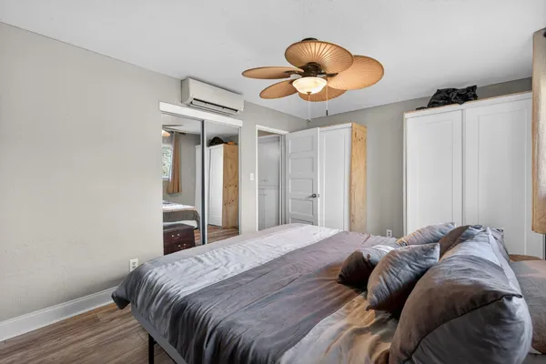 a bedroom with a bed and a chandelier