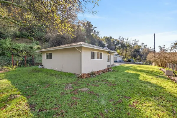 a view of a house with a backyard