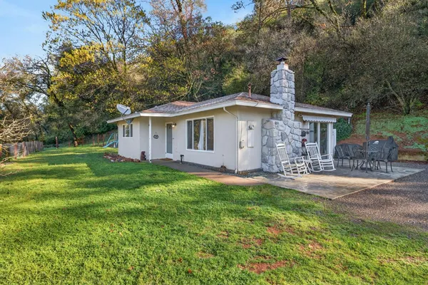 a front view of house with yard and green space