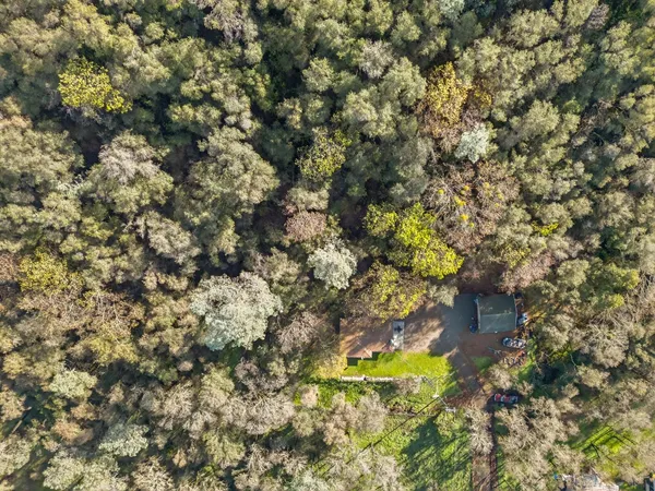 an aerial view of a house with a yard
