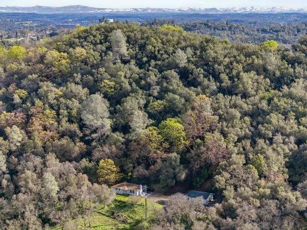 a backyard of a house with a yard and outdoor seating