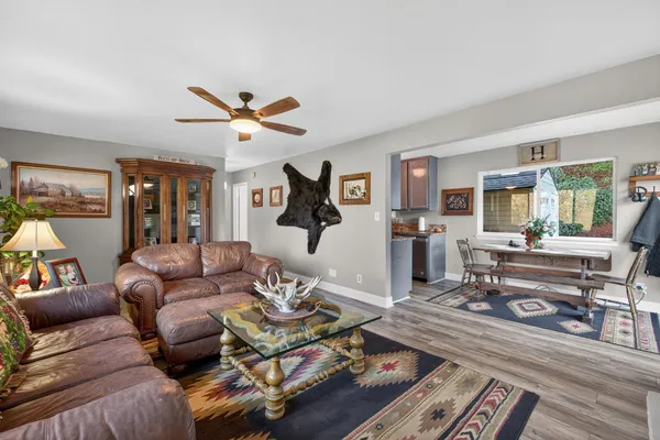 a living room with furniture a rug and a large window