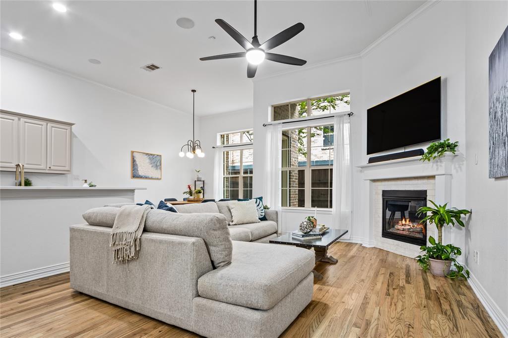 2205 Eriksson Lane Dallas, TX 75204 - Photo 1 of 18 a living room with furniture a fireplace and a flat screen tv
