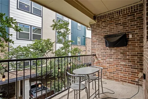 a view of a balcony with chair and potted plant