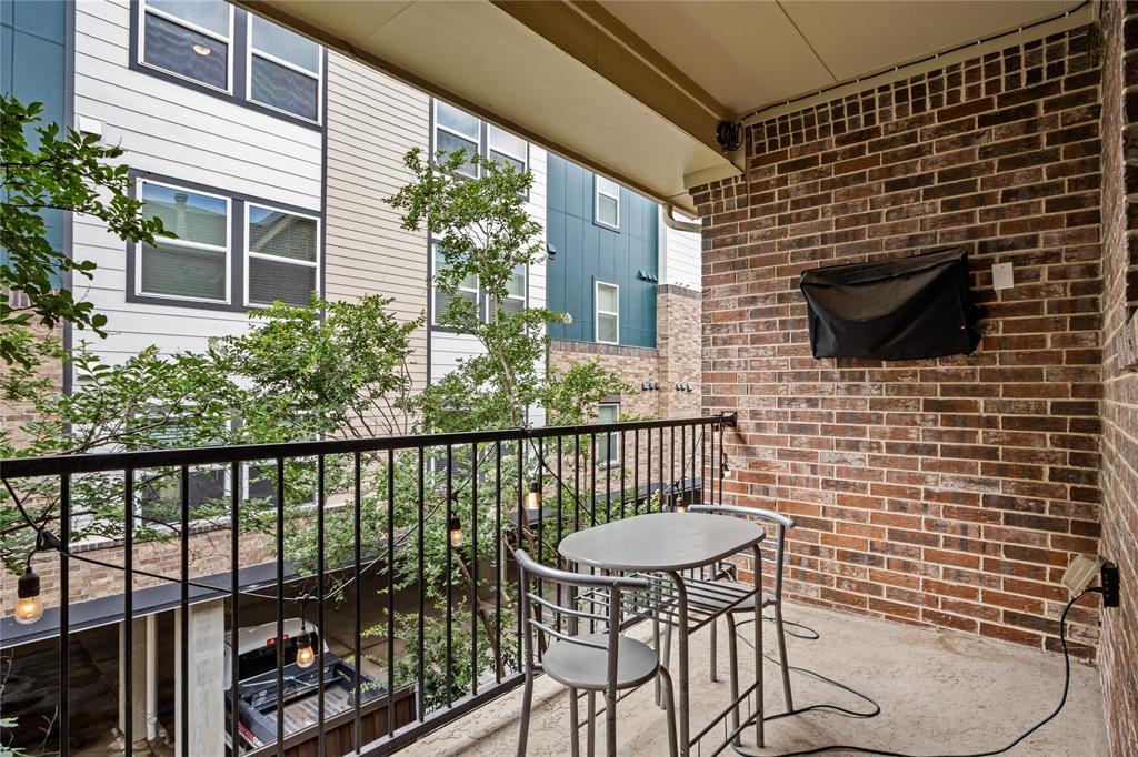 2205 Eriksson Lane Dallas, TX 75204 - Photo 11 of 18 a view of a balcony with chair and potted plant