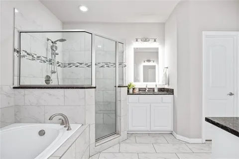 a bathroom with a bathtub and shower
