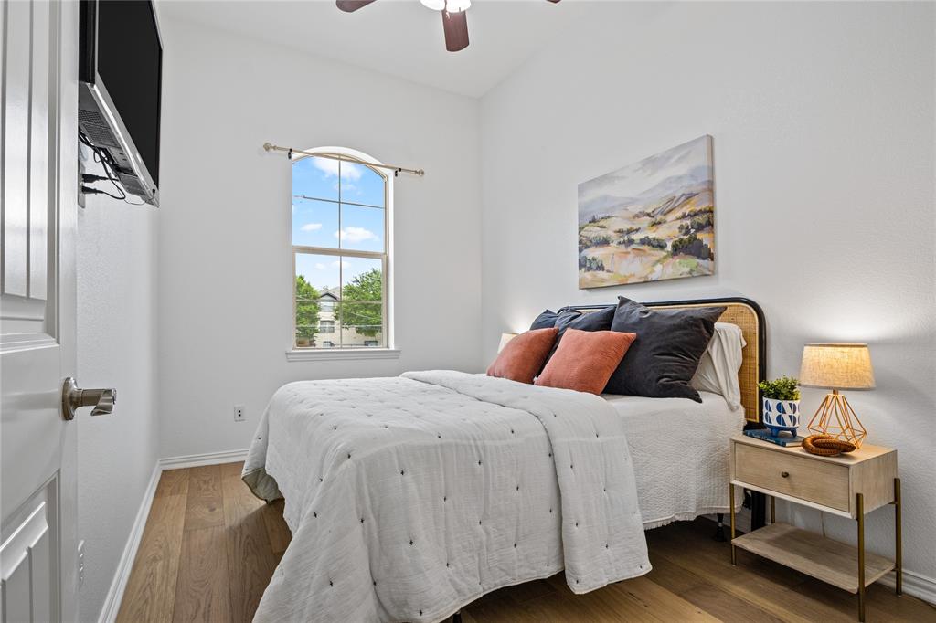 2205 Eriksson Lane Dallas, TX 75204 - Photo 16 of 18 a bedroom with a bed and wooden floor