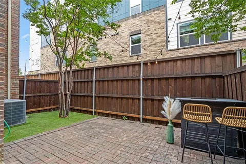 a view of a backyard with a large window and wooden fence