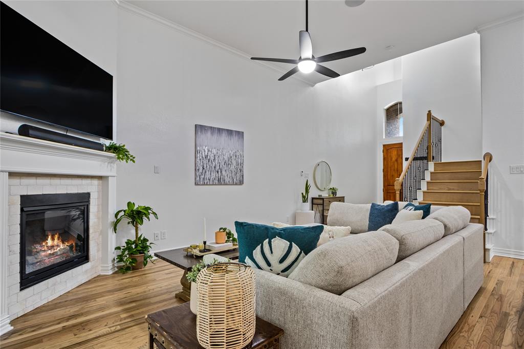 2205 Eriksson Lane Dallas, TX 75204 - Photo 4 of 18 a living room with furniture a flat screen tv and a fireplace