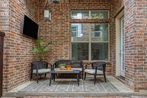 a brick house with table and chairs