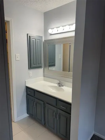 a bathroom with a double vanity sink and mirror