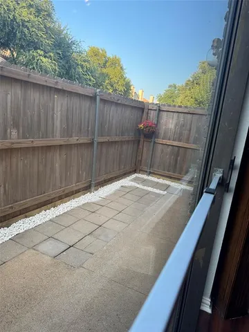 a backyard of a house with table and chairs