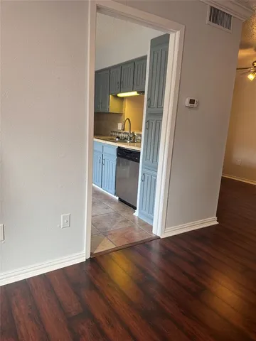 a view of a kitchen from a hallway