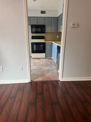 a view of kitchen and wooden floor
